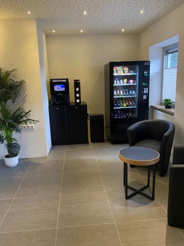 a waiting room with a soda machine in a store at Pension Alpina in Roppen