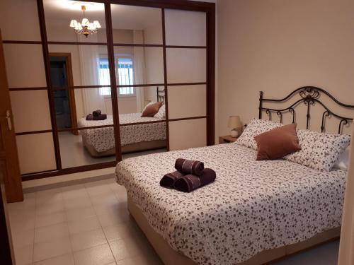 a bedroom with a bed and a large mirror at Casa Villa Ladi in Umbrete
