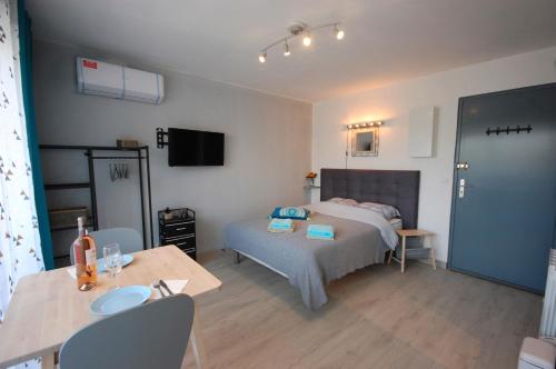 - une chambre avec un lit, une table et une table dans l'établissement Saphir de Gruissan, à Gruissan