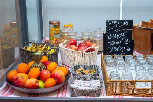 a table with baskets of fruit and bottles of water at ibis Recife Boa Viagem in Recife