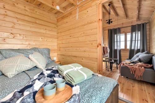 a log cabin bedroom with a bed and a table at Wood Village in Winiec