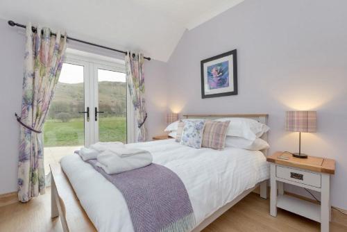 A bed or beds in a room at Balbeg Cottage