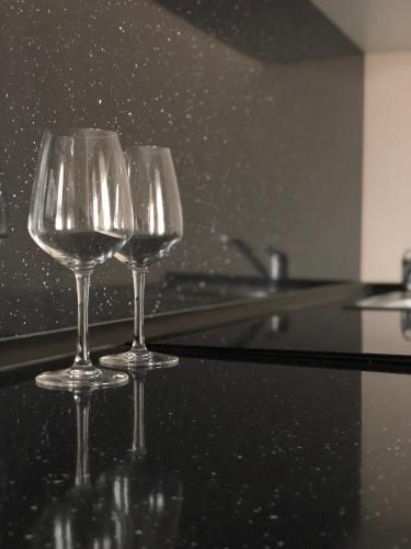two wine glasses sitting on top of a counter at Salve Teplice in Teplice
