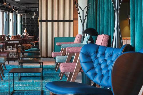 a row of chairs and tables in a store at Mövenpick Zagreb in Zagreb