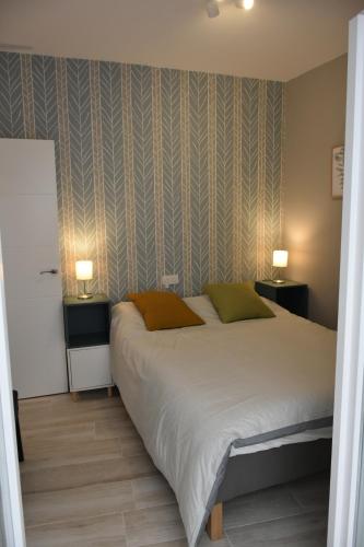 a bedroom with a large bed and two night stands at Sweet Arco Rosa Zona Centro in Cádiz