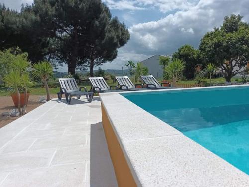a swimming pool with lounge chairs next to a pool at Casa do Lagar in Óbidos