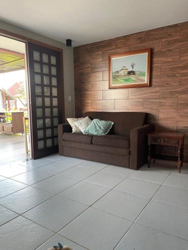 a living room with a couch and a picture on the wall at Chalé Serrano in Bananeiras
