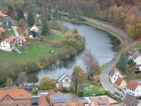 an aerial view of a town with a river at Haus Pfaffenfels in Schönau