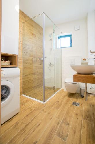 a bathroom with a shower and a toilet and a sink at Apartment Hanja in Bar