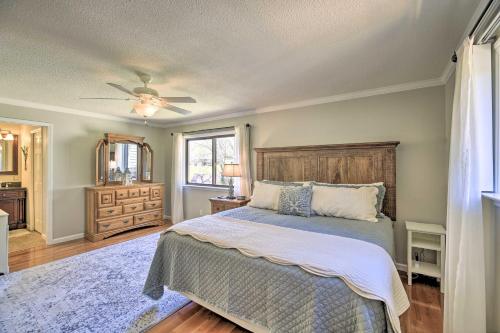 a bedroom with a bed and a ceiling fan at Lake House Haven Fire Pit, Boat Dock and More! in Watauga