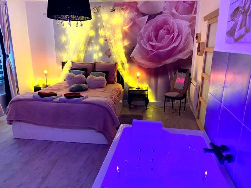 a bedroom with a bed with purple lights and a tub at COSY & SPA Appartement Luxe JACUZZI SAUNA Suite Cristal in Avignon