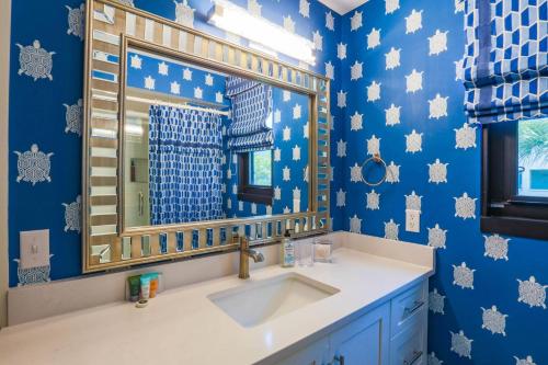 a bathroom with a sink and a mirror at Array of Sunshine Condo in Isle of Palms