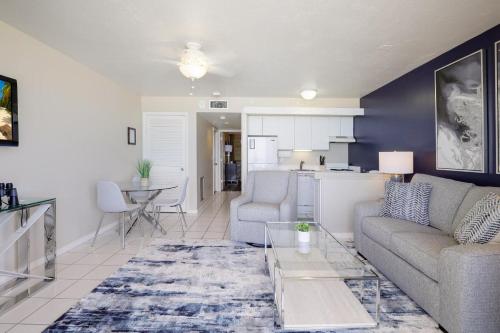 a living room with a couch and a table at Beachfront condo with restaurant, pool, spa and gym in Marco Island