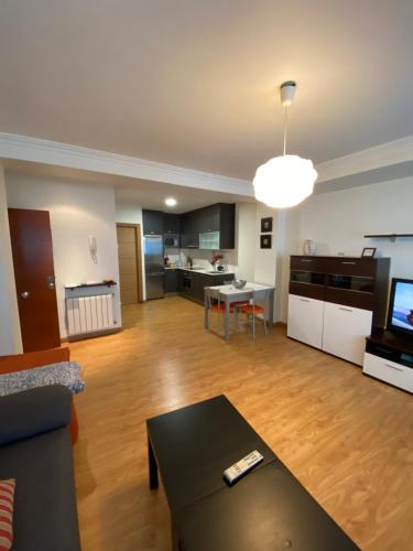 a living room with a couch and a table at Apartamento reformado en Portonovo in Portonovo