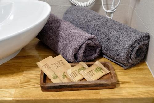 a bathroom with a sink and towels on a table at Office Park Aparthotel in Toruń