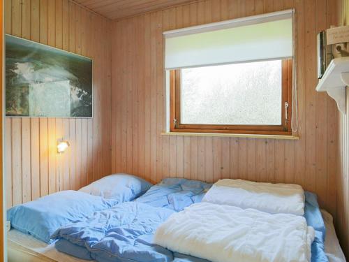 a bed in a room with a window at 6 person holiday home in Dannemare-By Traum in Dannemare
