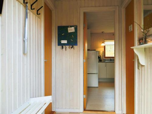 a hallway leading to a kitchen with a refrigerator at 6 person holiday home in Dannemare-By Traum in Dannemare