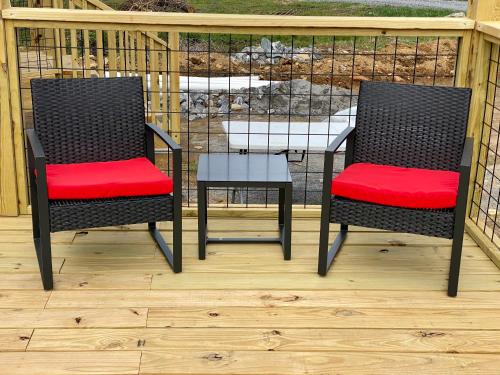 two chairs and a table on a deck at Maggie Valley Cabin Rentals in Maggie Valley