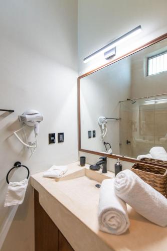 a bathroom with a sink and a large mirror at Casa Balada Santa Lucía with Parking by Cercana in Mérida