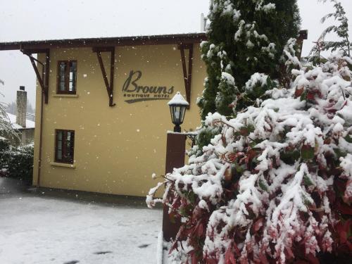 
a snow covered building with a fire hydrant on top of it at Browns Boutique Hotel in Queenstown
