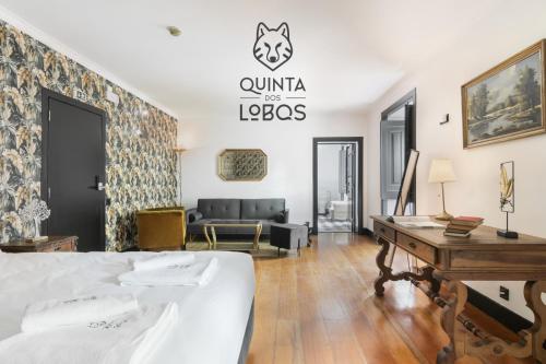 a bedroom with a bed and a living room at Quinta dos Lobos Boutique Hotel - Nature Experience in Sintra