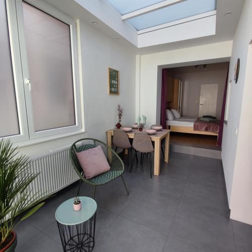 a room with a table and chairs and a bedroom at Apartment Villa Ksenija in Ostend