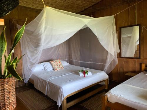 Katil atau katil-katil dalam bilik di Posada Villa Margarita