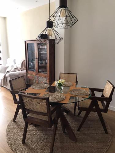 a dining room with a wooden table and chairs at Apartamento Palacio Valdés, centro Avilés, con parking in Avilés
