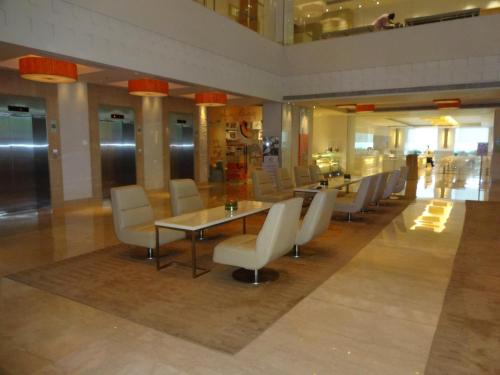 a dining room with tables and chairs in a building at The Raintree, Anna Salai in Chennai