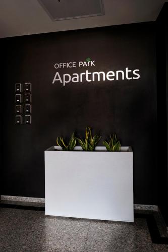 a sign that says office park apartments on a wall at Office Park Aparthotel in Toruń