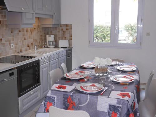 a kitchen with a table with a table cloth on it at Holiday Home in Guissény near Beaches in Guissény