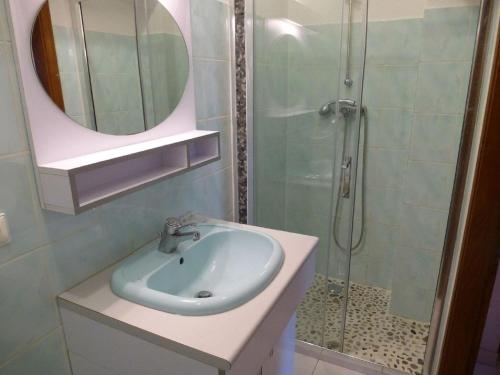 a bathroom with a sink and a shower with a mirror at Villa in Sainte-Maxime near La Nartelle Beach in La Nartelle