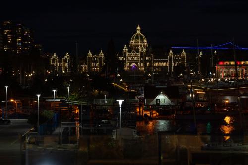 a view of a large building at night at Victoria Regent Waterfront Hotel & Suites in Victoria