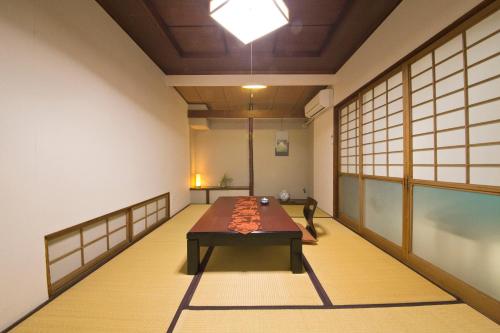 a room with a table in the middle of it at Ryokan Seifuso in Ōmuta