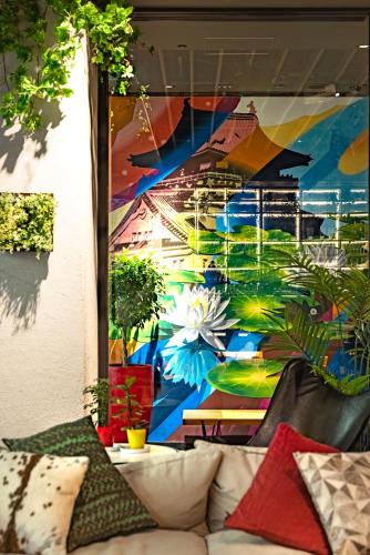 a mural on the side of a building with a couch at ibis Osaka Umeda in Osaka
