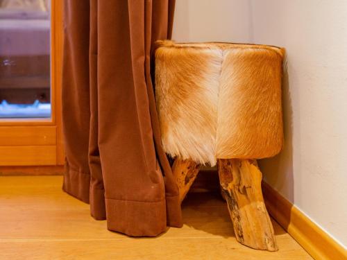 a wooden chair sitting next to a curtain at Eichenhof in Alpendorf