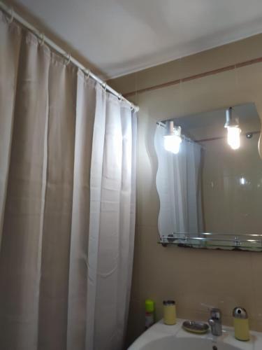 La salle de bains est pourvue d'un rideau de douche blanc et d'un lavabo. dans l'établissement Precioso apartamento con garaje en Avenida Andalucía 77 playa Mezquitilla, à Algarrobo