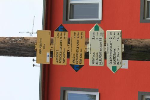 a chime hanging from a red building with a red door at Penzion u Janky in Dubňany