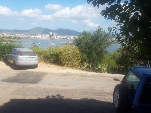 a car parked on the side of a road near the water at Appartamento Olbia Panoramica Mare in Olbia