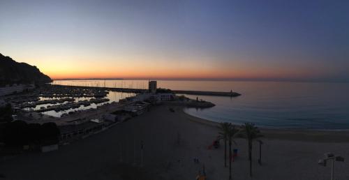 a view of a beach at sunset with a pier at Skyblue in Aguadulce