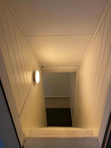 a staircase in a house with a light on it at Mosjøen Overnatting, Tordenskjolds gate 24b in Mosjøen
