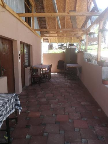 a patio with tables and chairs in a building at Odmaralište Vlaško ždrelo in Pirot