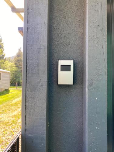 a white box on the side of a wall at S-CHALET Camping mit Comfort im Schwarzwald in Steinach