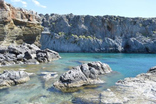 a river with rocks in the middle of a canyon at Zeus Traditional House in Mitrópolis