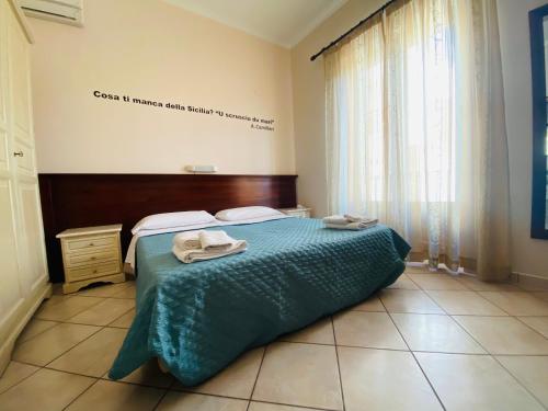 
a bed in a room with a white bedspread at Mamamia Lipari in Lipari
