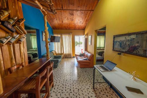 a room with a desk with a laptop on it at Casa Los Patios in Jericó