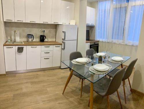 a kitchen with a glass table and chairs in a room at Comfy & Stylish in Varna City