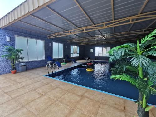 a large room with a pool with plants in it at Villa Salassel Al Jabal Al Akhdar فلة سلاسل الجبل الأخضر in Al ‘Ayn