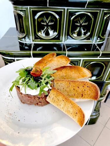a plate with a sandwich with bread on it at Penzion U Nováků in Kožlí u Orlíka