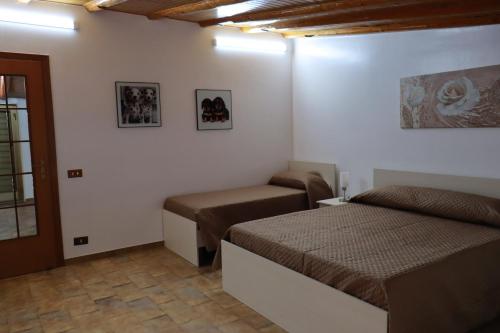 - une petite chambre avec 2 lits et une fenêtre dans l'établissement Attico La Terrazza, à Viagrande